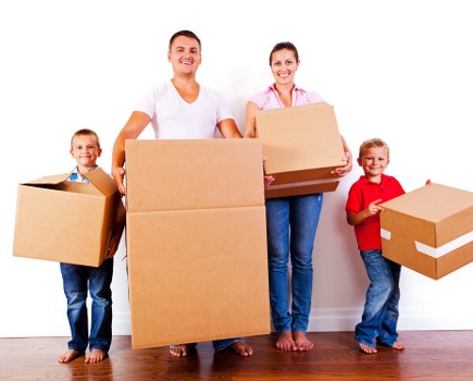 Furniture pickup team handling a bulky sofa in a Bowespark home