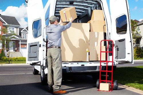 Local house movers handling boxes and furniture on a Bowespark street