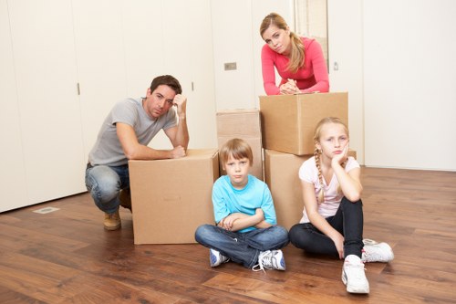 Furniture and boxes being moved in a Bowespark property with tight access
