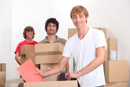 Team loading furniture and packed boxes for a local house removal